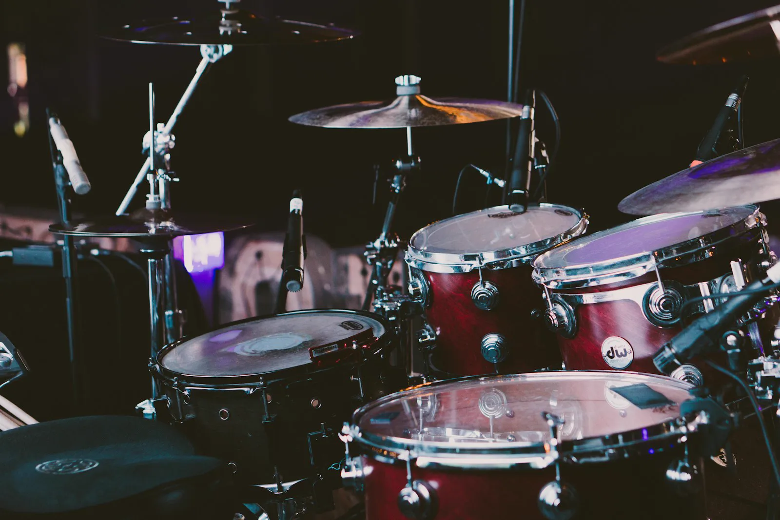 Crimson drum kit under stage lighting