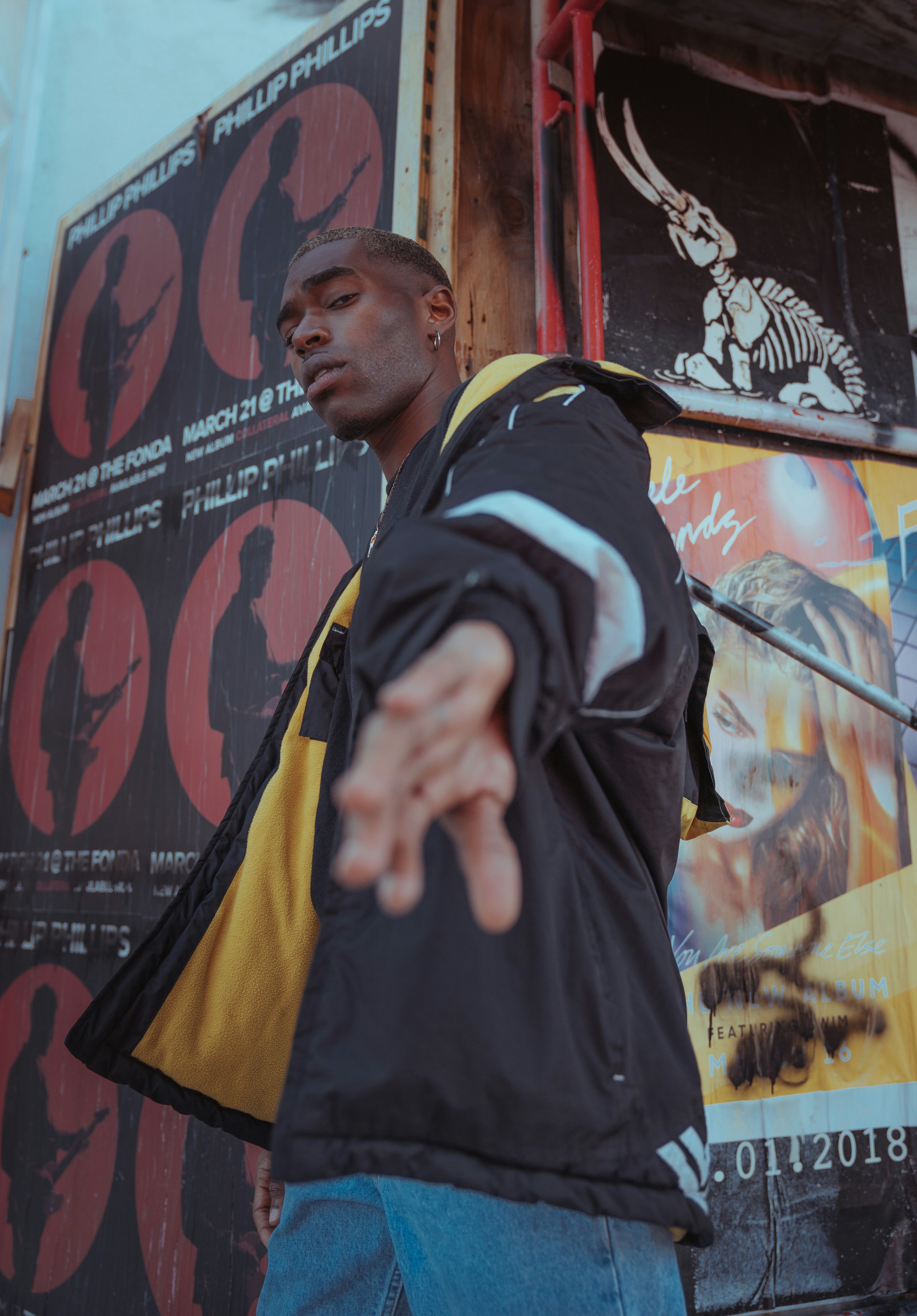 Model in windbreaker against posters